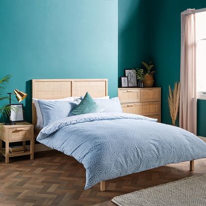 bedroom with wooden flooring and bed