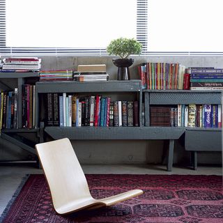 home office with book shelves and concrete flooring