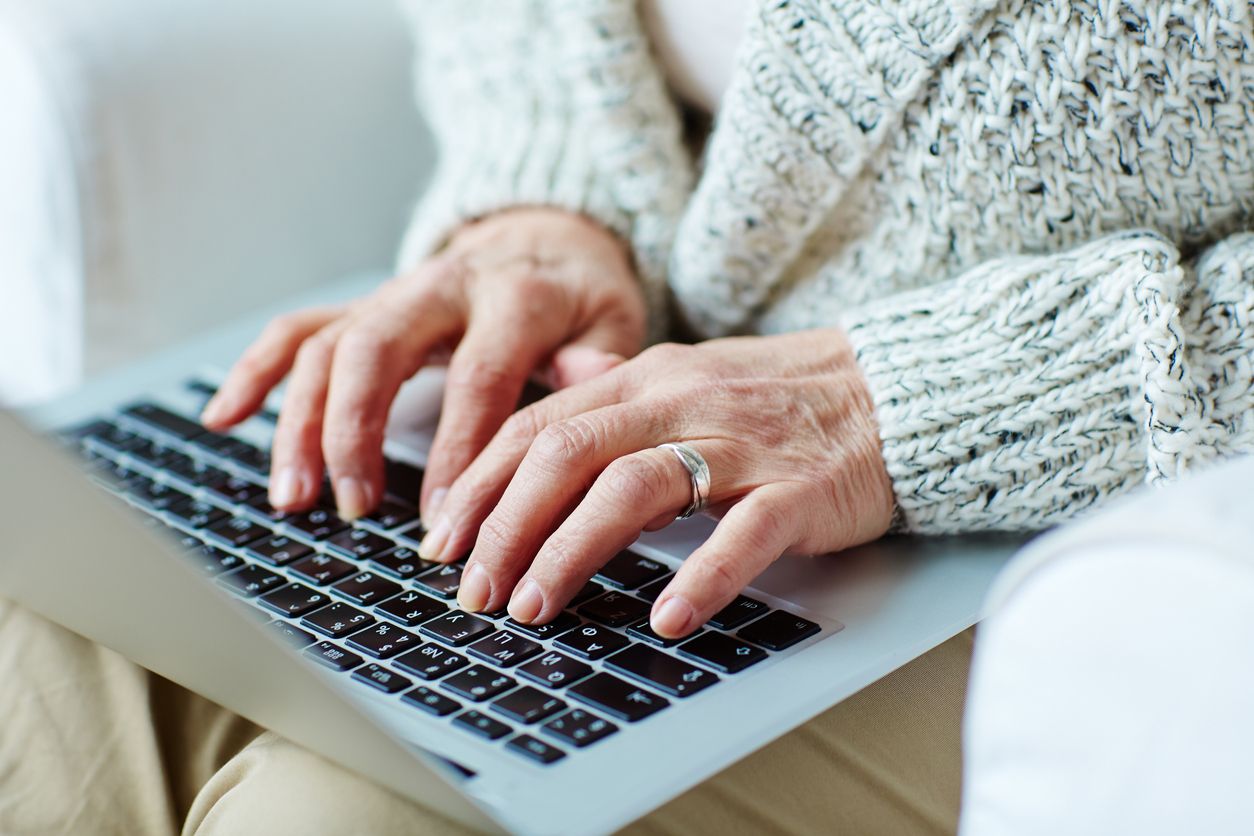 A woman types on a laptop.