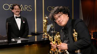 Bong Joon-ho with his multiple Oscars