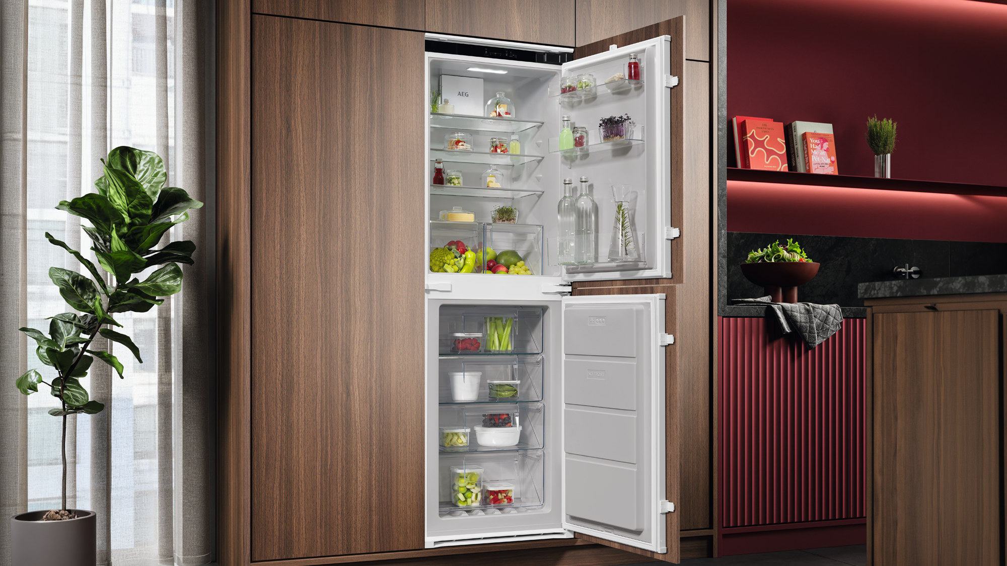 Refrigerator opened with food in. In a kitchen with a plant by the window