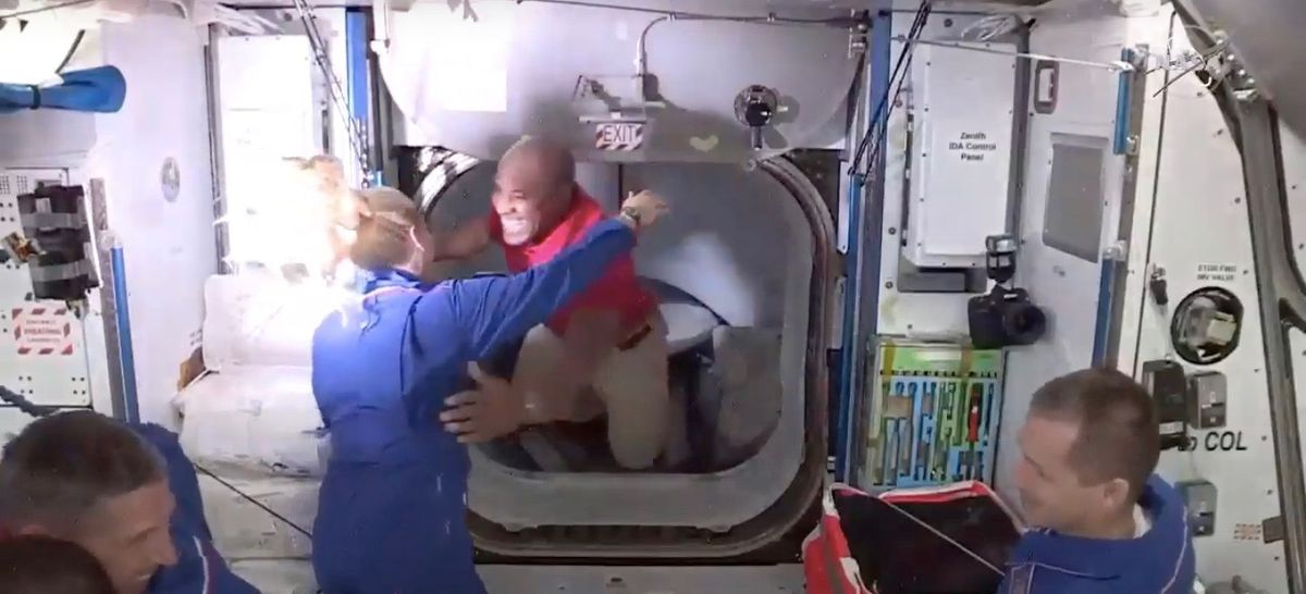 Victor Glover (center) hugs fellow NASA astronaut Kate Rubins just after floating aboard the International Space station from the SpaceX Crew Dragon capsule &quot;Resilience&quot; early on the morning of Nov. 17, 2020.