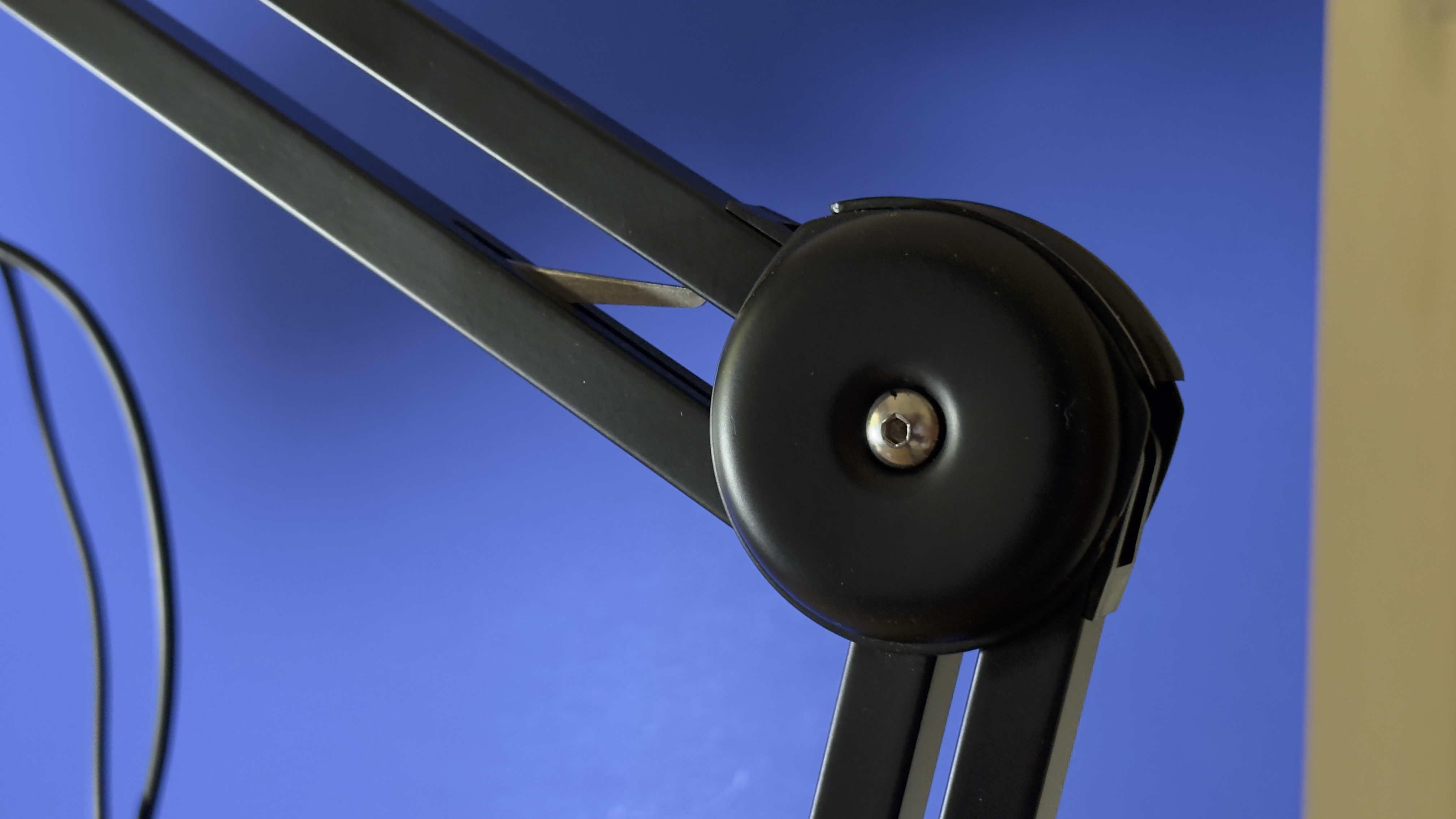 Close-up of a rotating joint on the Maono boom arm with a metal slider that makes the rotated arm stay in the desired position
