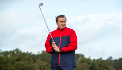 A golfer wears the Ashworth Waterproof Rain Jacket