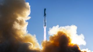 The world's largest rocket launches into a blue sky on SpaceX's Flight 7.