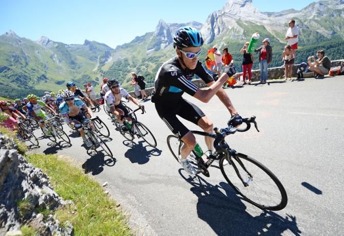Chris Froome discards his water bottle on the climb of the Col d'Aubisque in the heart of the Pyrenees, ahead of Mark Cavendish and Levi Leipheimer