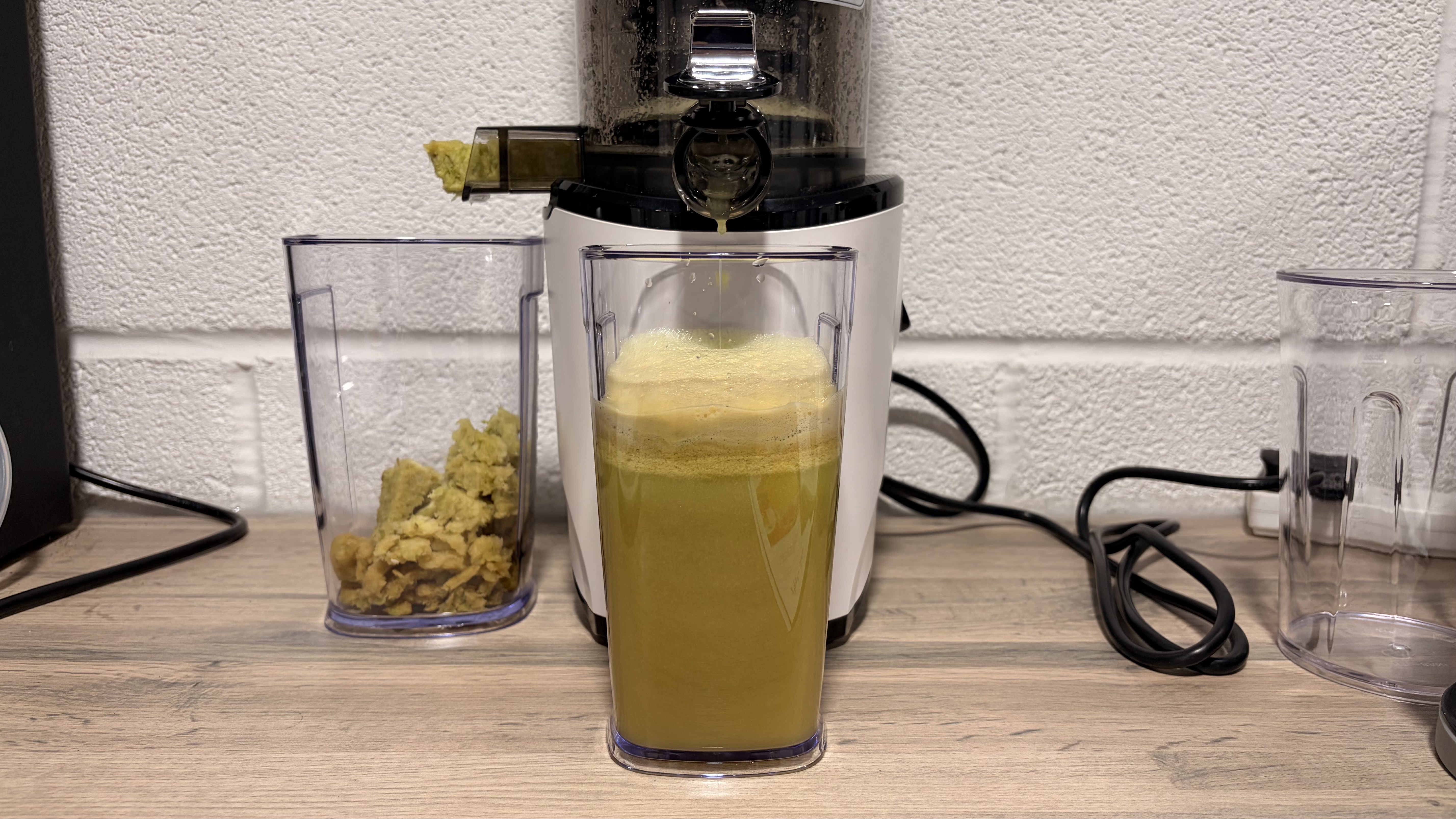 Green apple juice made using the Kuvings Auto8 hands-free slow juicer.