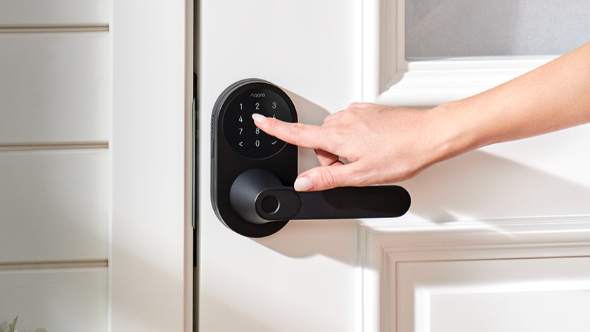 Woman&#039;s hand using Aqara Smart Lock U300