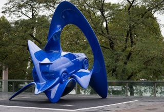 Giant blue art sculpture of land rover - back view