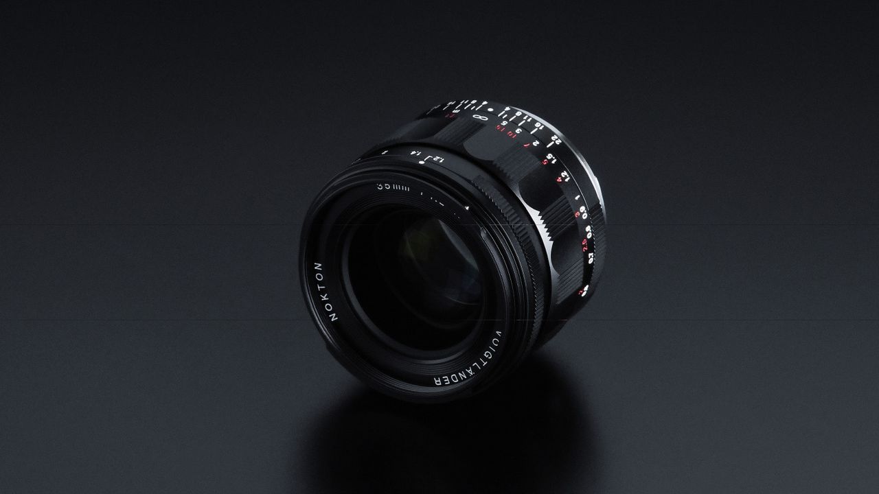 Close-up of NOKTON 35mm F1.2 Aspherical IV lens, showcasing its detailed markings on a smooth black surface