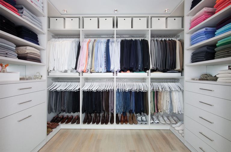 a color organized closet of men's clothes