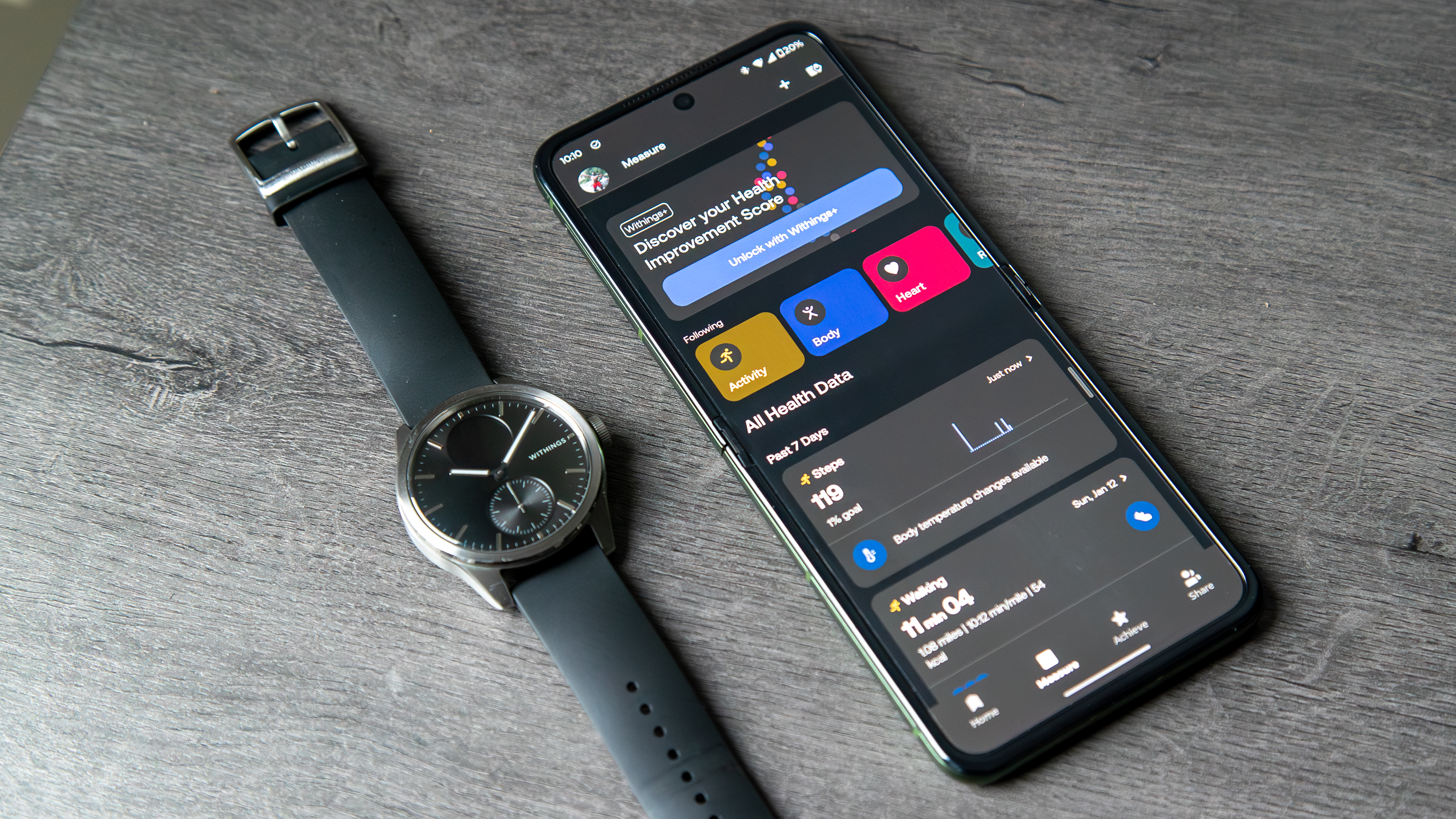 The Withings ScanWatch 2 next to a phone with the Withings app open