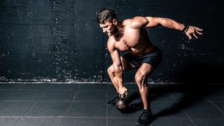 a photo of a man with a kettlebell