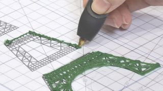 The best 3D pens; a photo of a 3D pen drawing the Eiffel Tower on a piece of paper