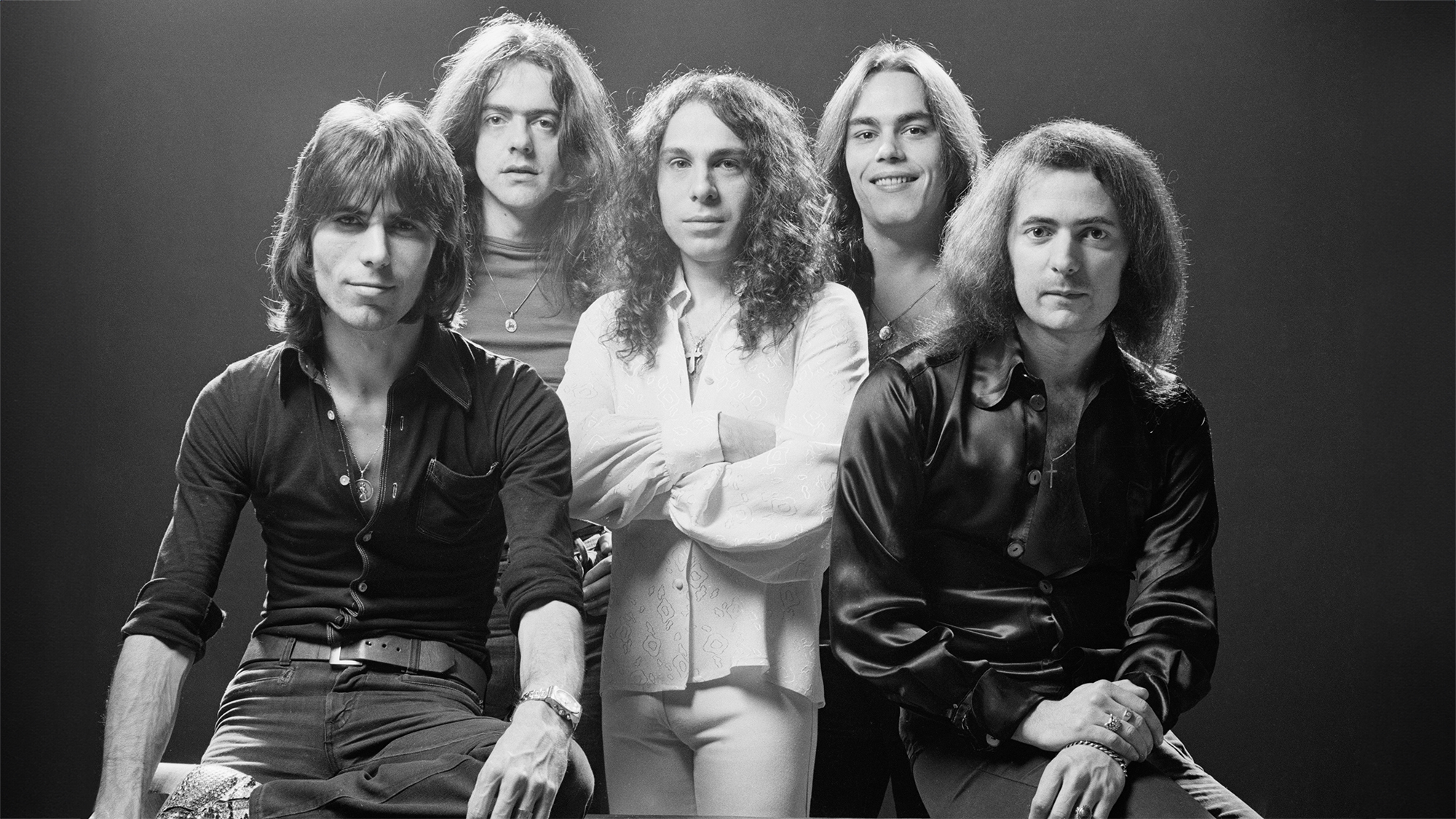 Rainbow (drummer Cozy Powell (1947-1998), singer Ronnie James Dio (1942-2010), keyboard player Tony Carey, bassist Jimmy Bain and guitarist Ritchie Blackmore), British rock band, pose for a group studio portrait for use on the cover of the band's album, 'Rising', in 1976.