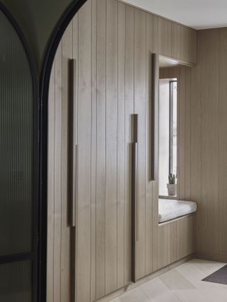 Hallway with built in panelled cupboards
