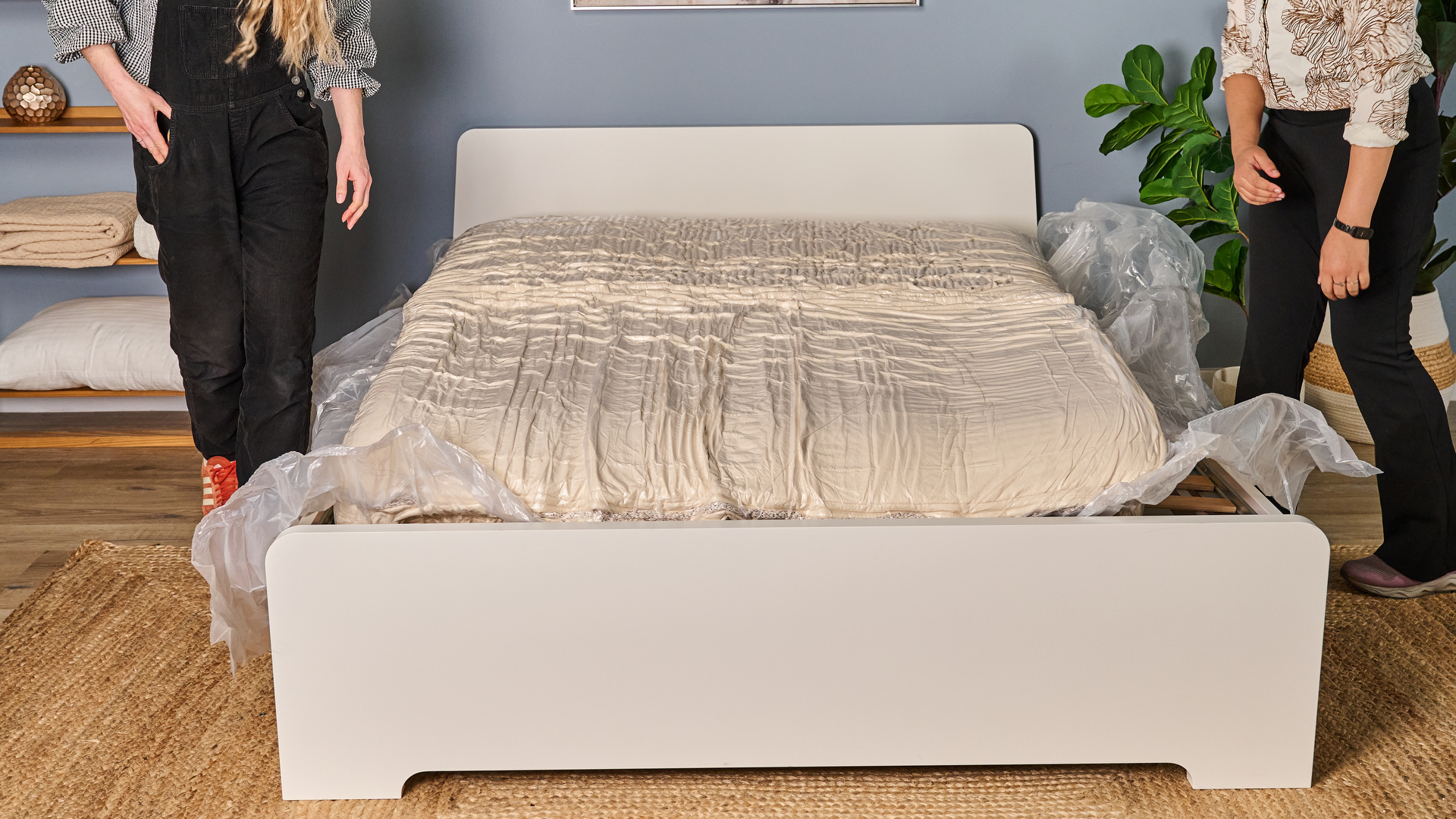 The Birch Luxe Natural mattress vacuum packed in plastic but lying flat on a bedframe