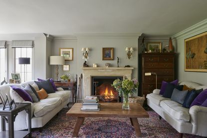 Living room with cream sofas and fireplace