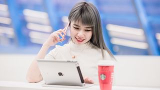 Apple Student Discount - female student using an iPad on campus