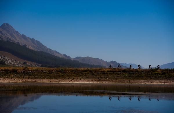 Racers cruise along with the backdrop of spectacular scenery