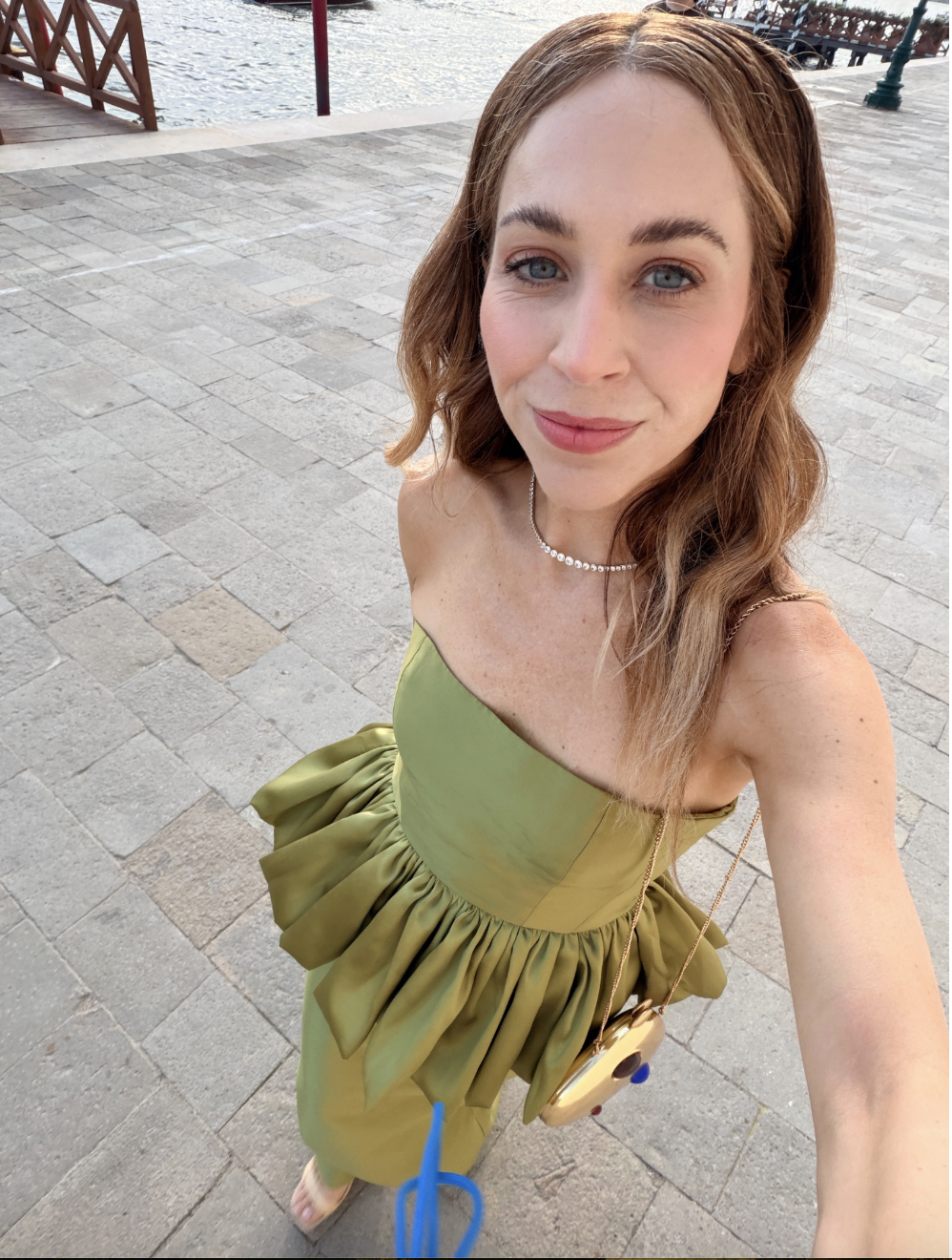 Jaclyn Johnson selfie on the street in a green top and jeans