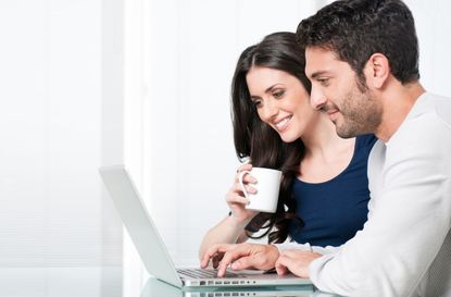 Smiling couple with laptop