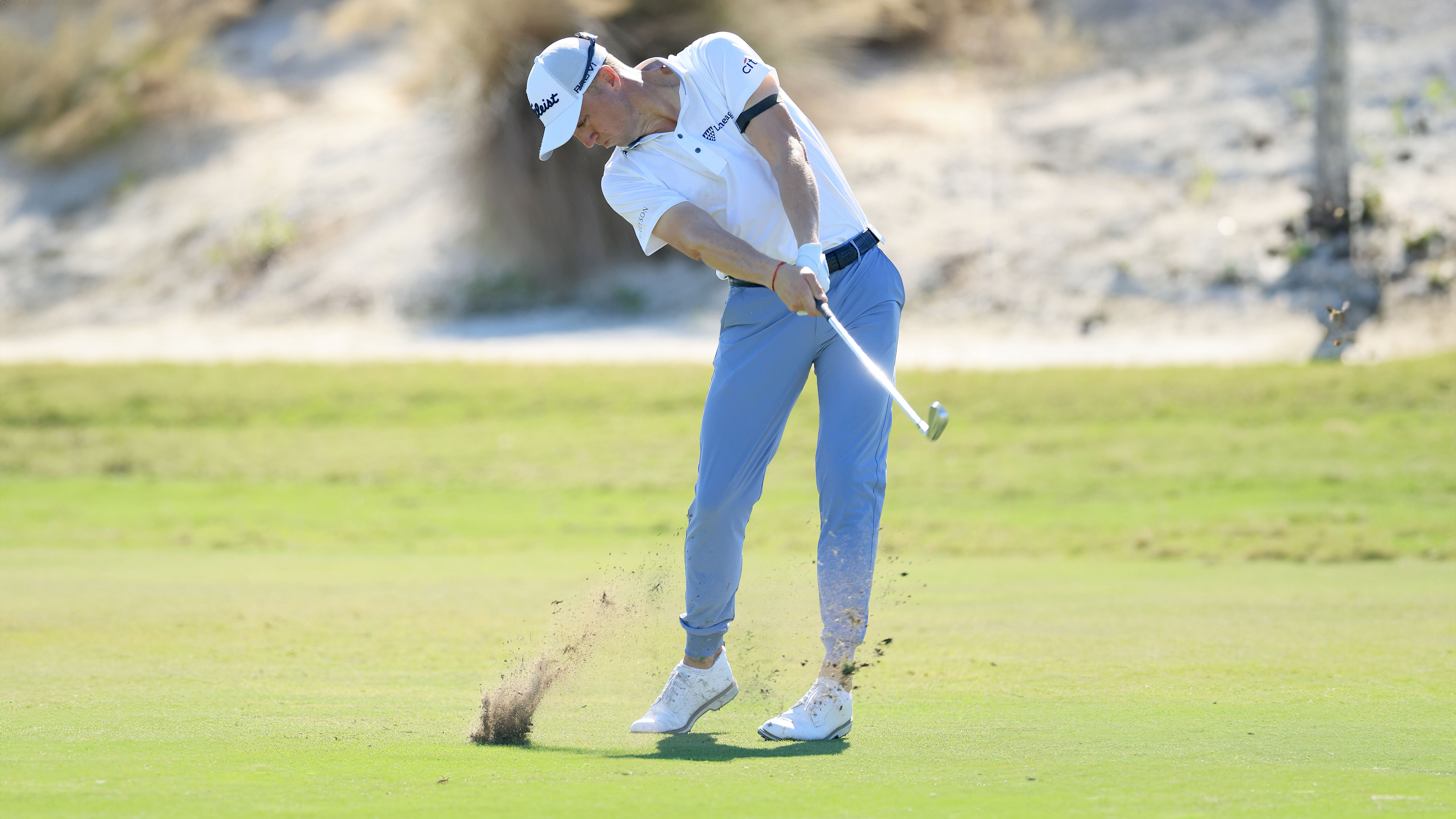 Golfer Justin Thomas hitting a 7-iron
