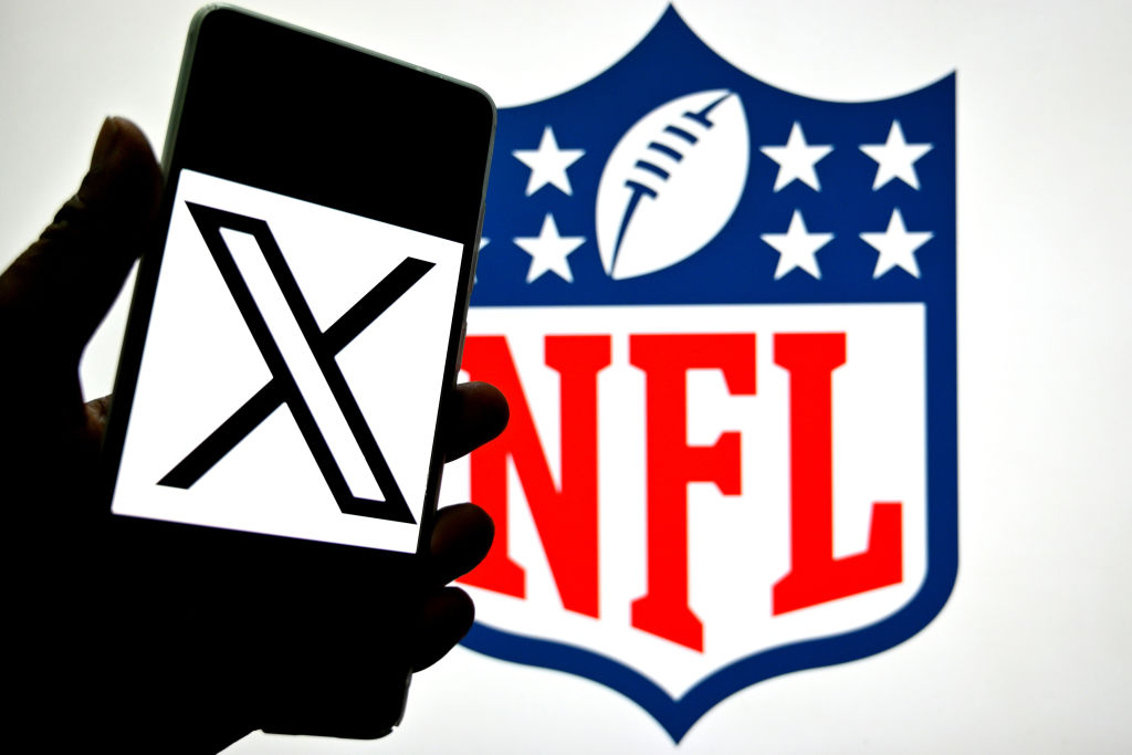 INDIA - 2025/03/20: In this photo illustration, a X (Twitter) logo is seen displayed on a smartphone with a NFL logo in the background. (Photo Illustration by Avishek Das/SOPA Images/LightRocket via Getty Images)