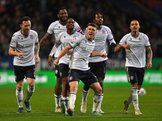 Bolton Wanderers players celebrate a goal against Oxford United in League One in March 2024.
