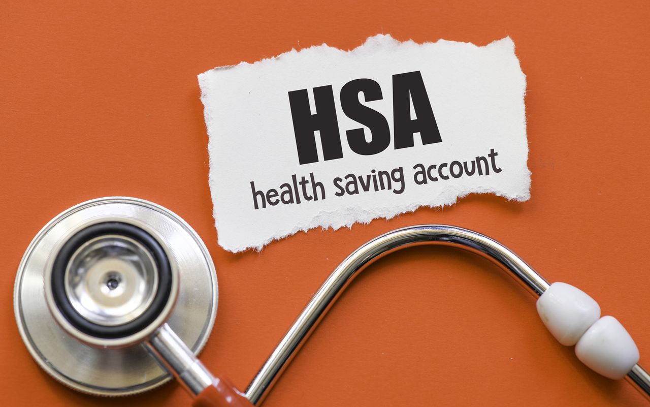 HSA health saving account words on a small piece of paper.