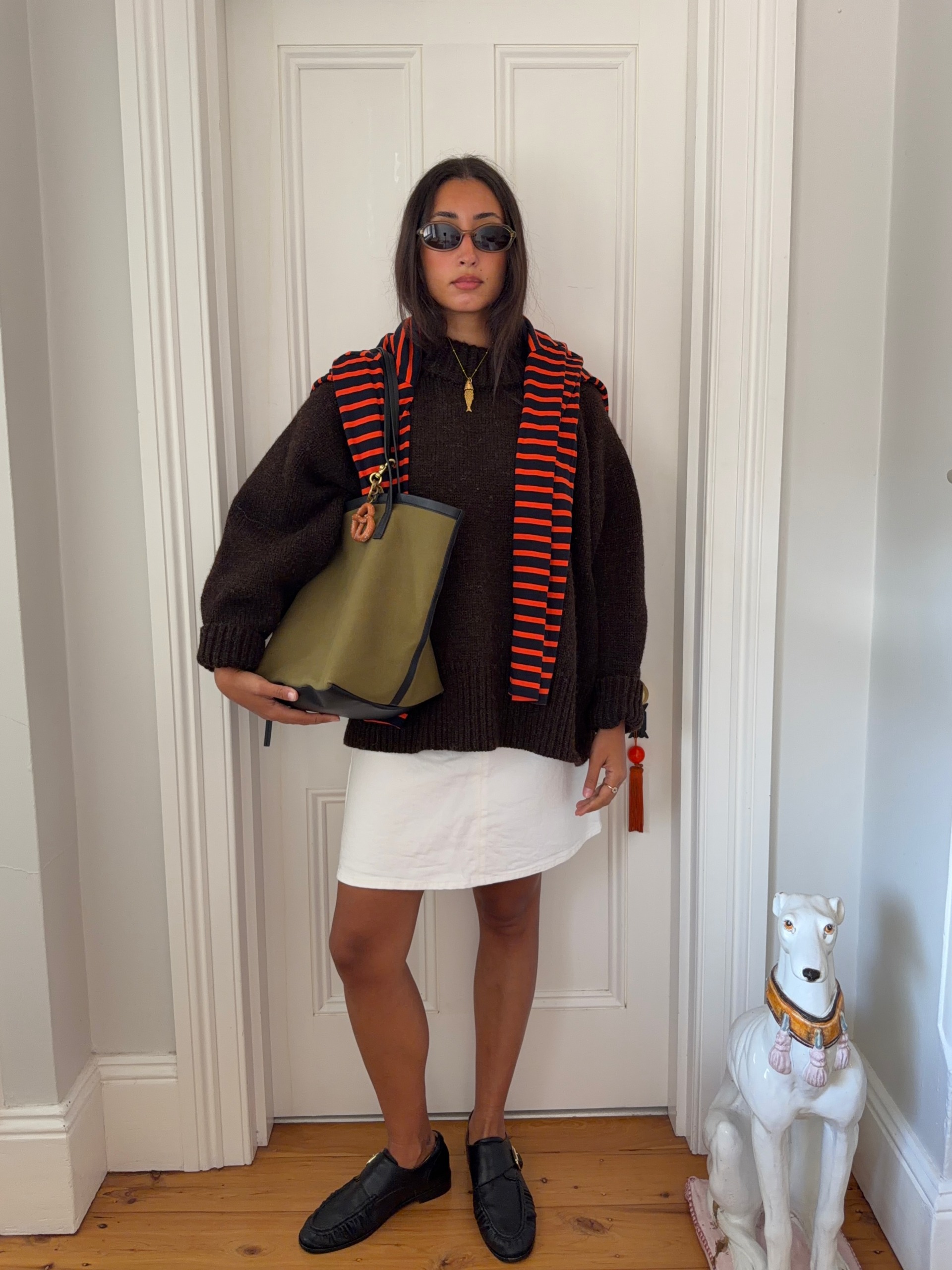 A woman wearing a fall sweater outfit in 2026.