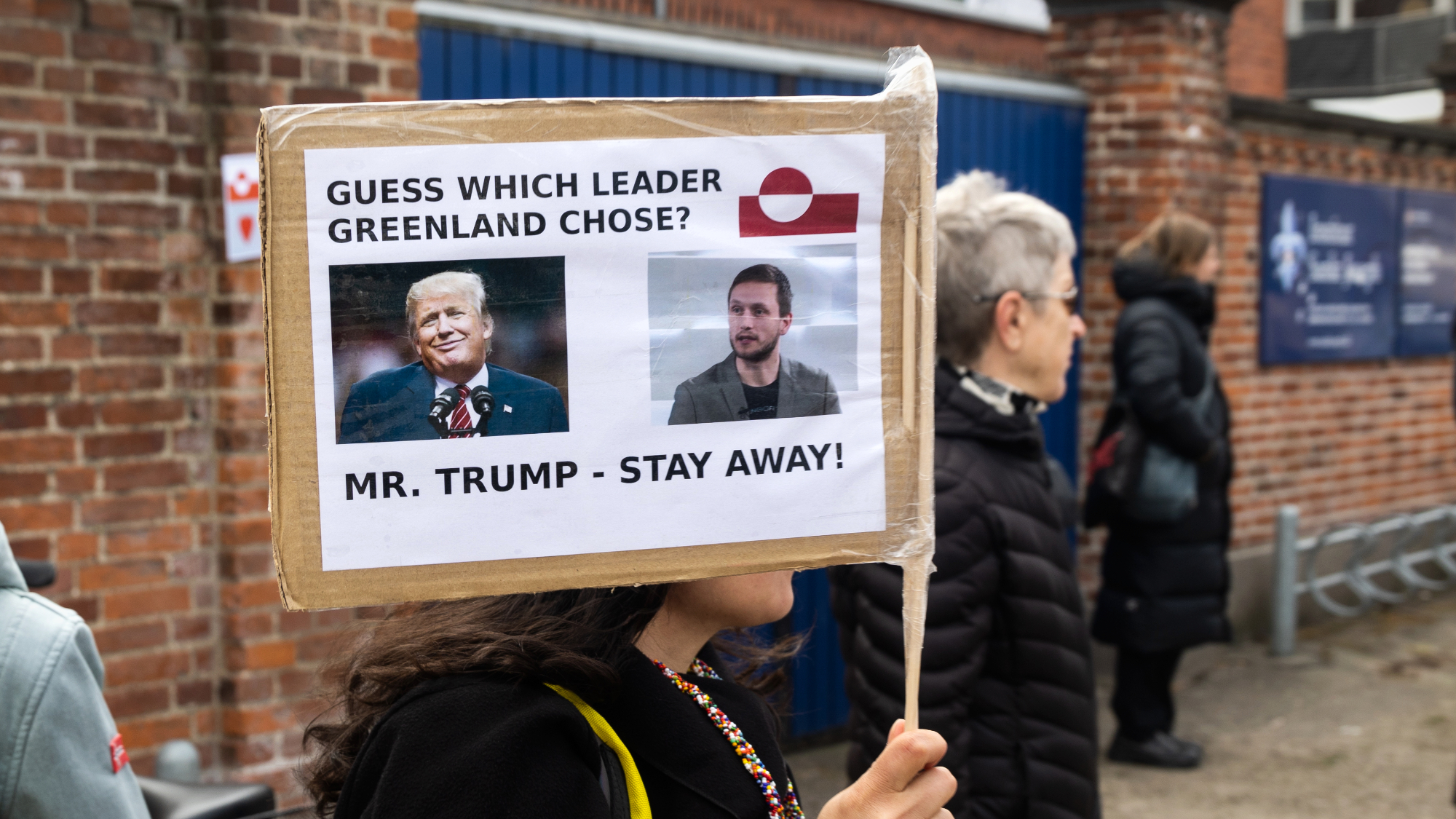 Protester in Copenhagen holds sign against President Donald Trump's bid to seize Greenland