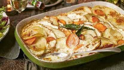 A large green dish of roasted root vegetable gratin