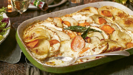 A large green dish of roasted root vegetable gratin