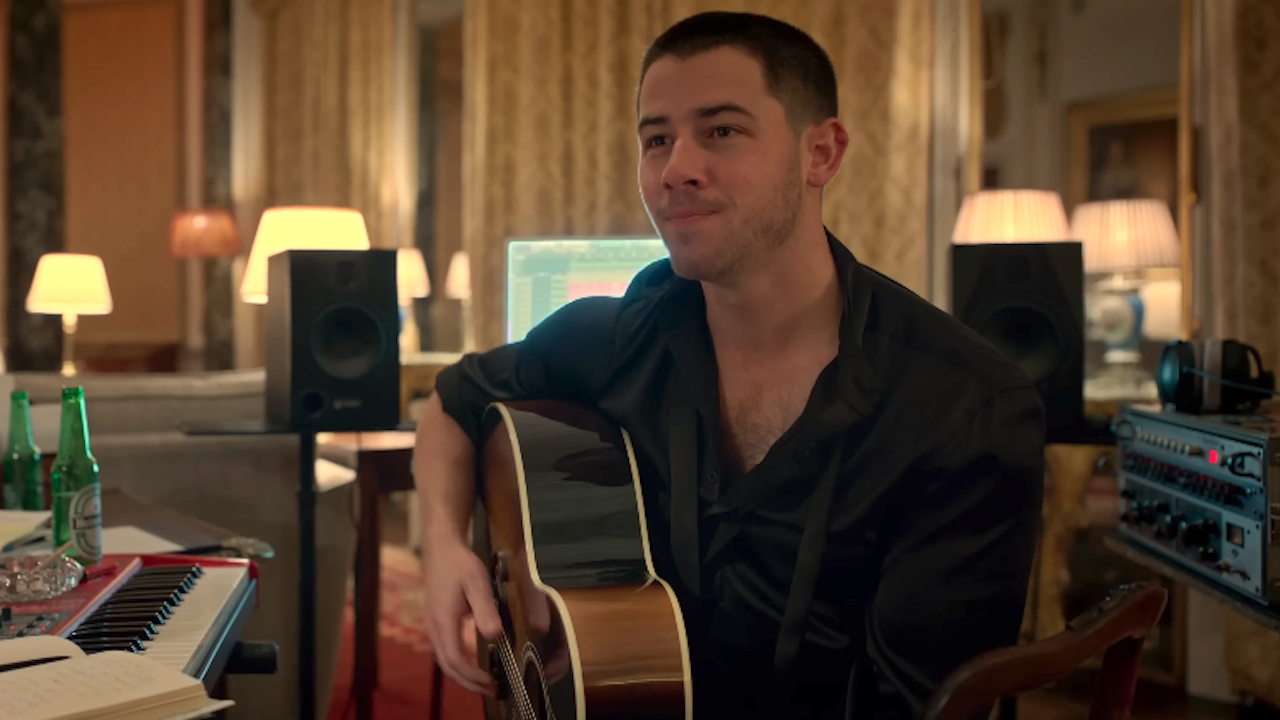 Nick Jonas holding a guitar in Power Ballad