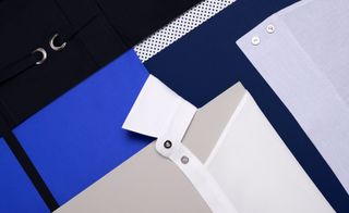 The top part of a white shirt on a blue background