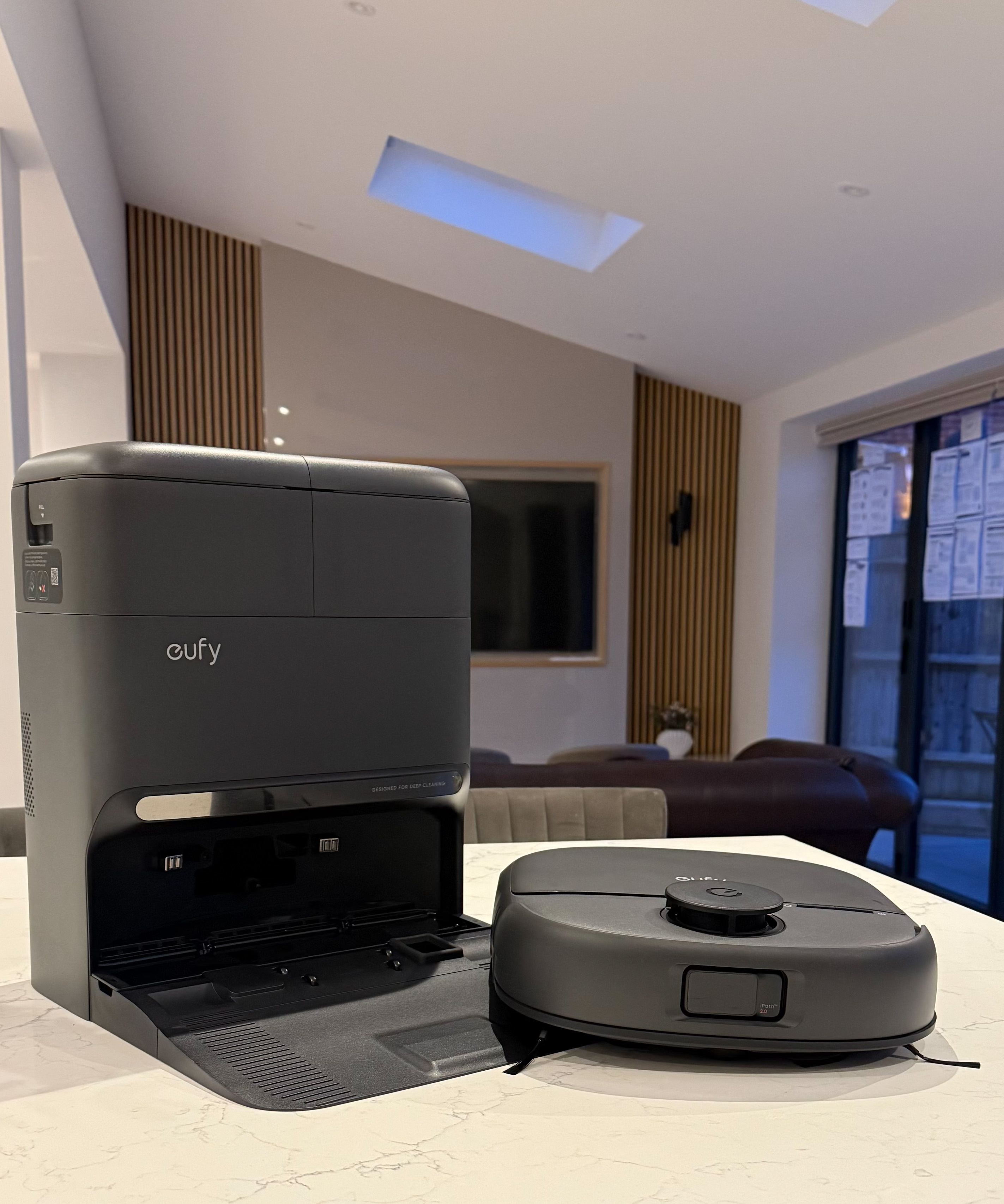 Eufy Omni C28 robot vacuum and self-emptying base station on kitchen counter