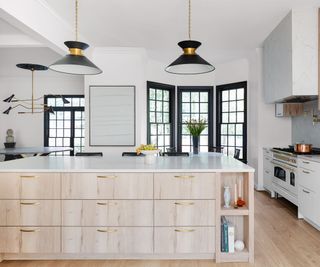kitchen with white walls and large wood finished island and wooden floors