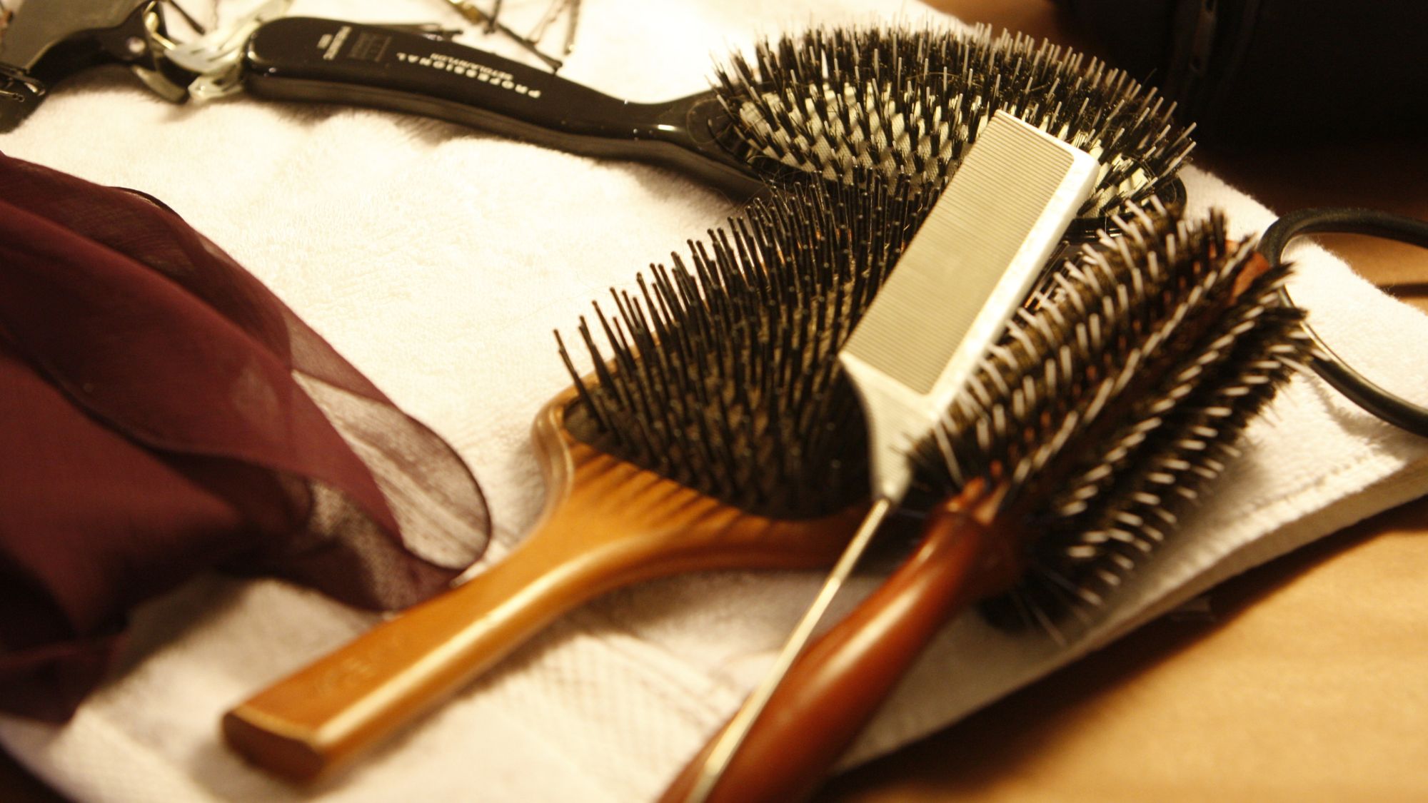 A closeup of hair brushes backstage during fashion week - how to clean your hairbrush