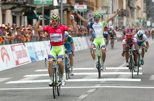 Daniel Oss celebrates behind as Viviani takes the stage