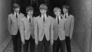 UNITED KINGDOM - circa 1963: English rock and roll group The Rolling Stones posed wearing matching houndstooth check jackets and dark grey trousers circa 1963. From left to right; Charlie Watts, Bill Wyman, Mick Jagger, Brian Jones (1942-1969) and Keith Richards. (Photo by Mark Hayward Archive/Redferns)