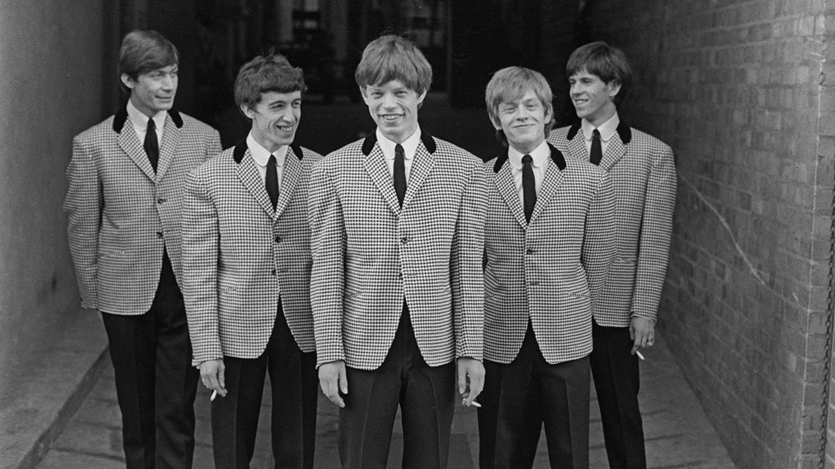 UNITED KINGDOM - circa 1963: English rock and roll group The Rolling Stones posed wearing matching houndstooth check jackets and dark grey trousers circa 1963. From left to right; Charlie Watts, Bill Wyman, Mick Jagger, Brian Jones (1942-1969) and Keith Richards. (Photo by Mark Hayward Archive/Redferns)