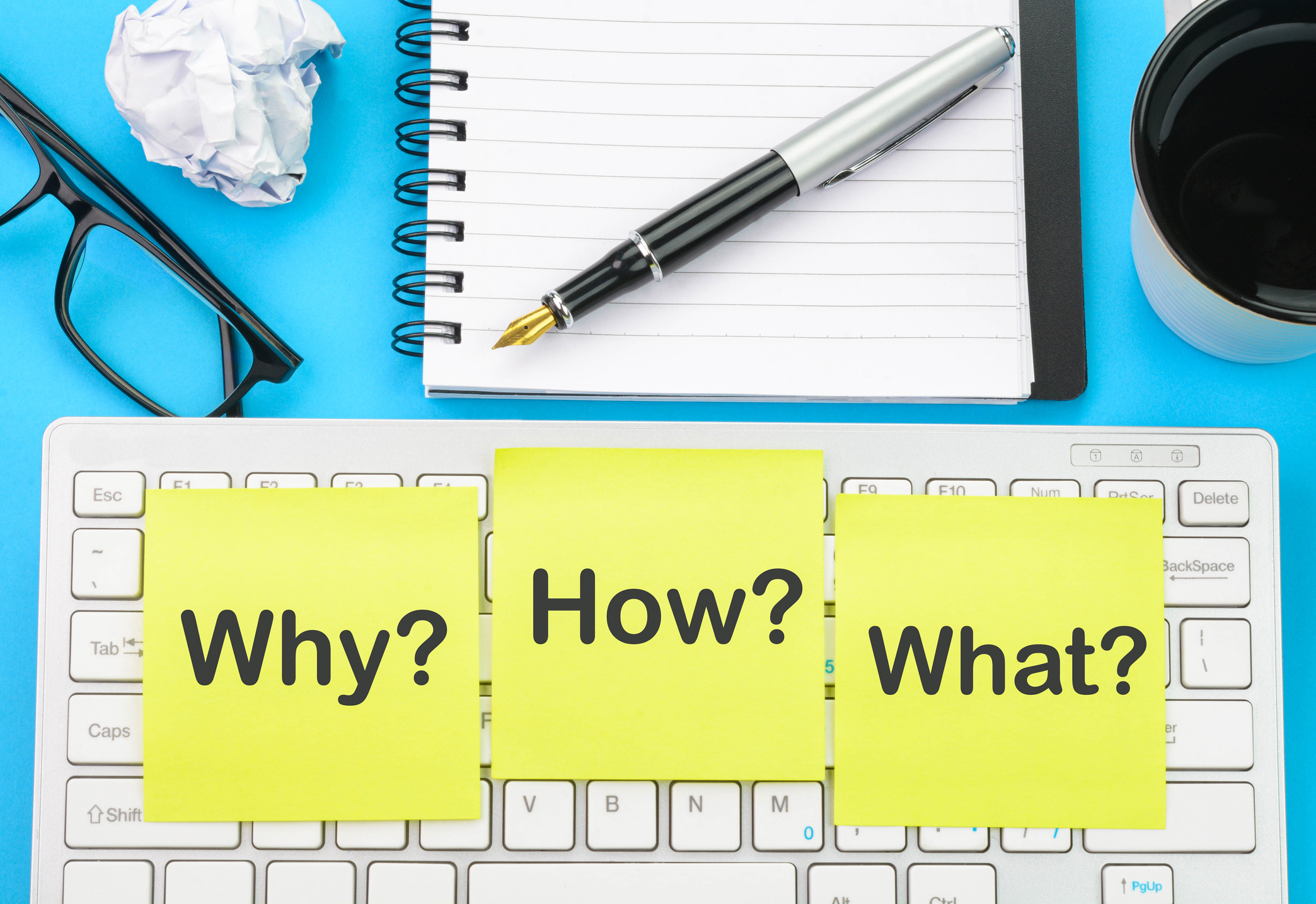 Asking questions why, how and what text written on sticky notes.