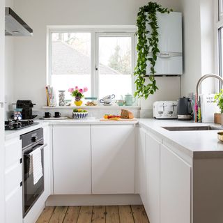 kitchen with white coloured wall and windows