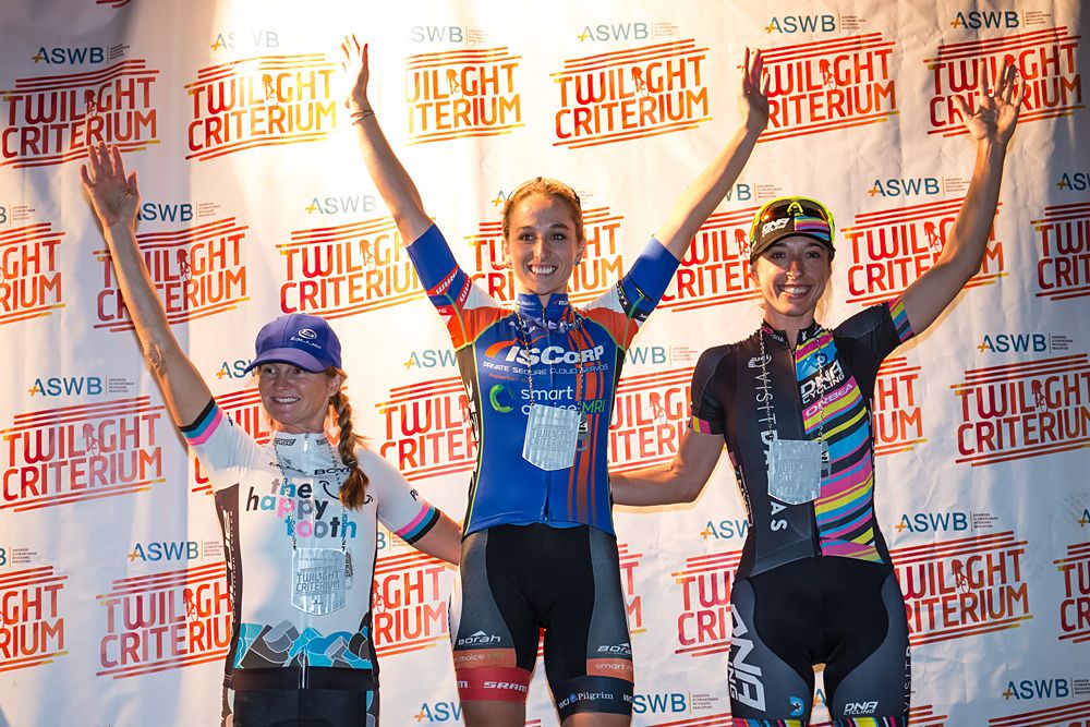 Christina Gokey Smith, Sam Schneider and Mindy McCutcheon on the podium