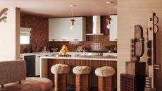 Tiled, beige-tinted kitchen with Island and fuzzy bar stools
