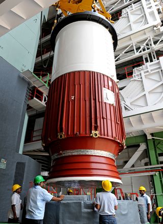 The first stage of a Polar Satellite Launch Vehicle, the rocket to launch India's 100th space mission, is moved into position during rocket assembly.