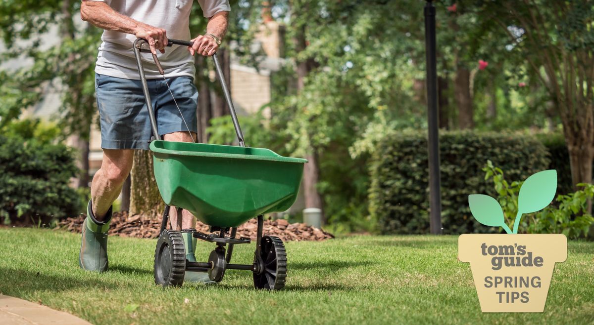 A man pushing a wheelbarrow across a fresh lawn