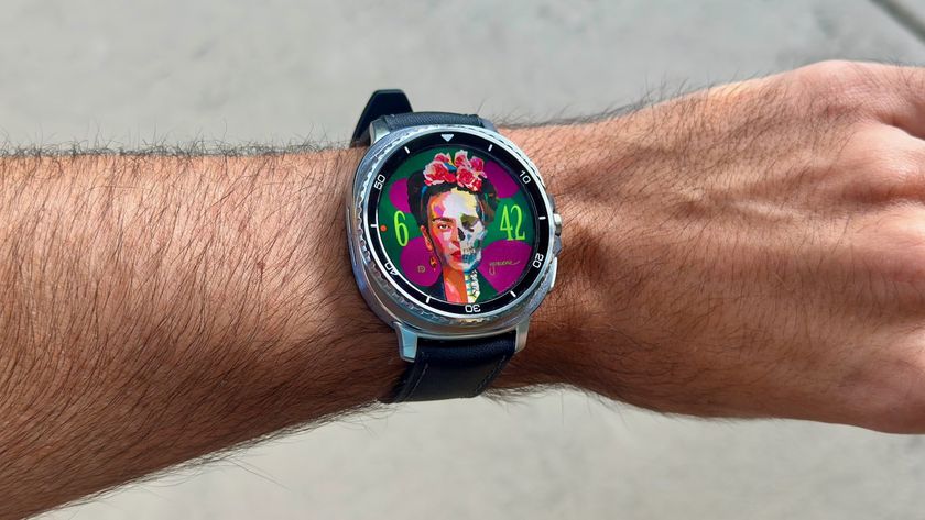 The Samsung Galaxy Watch 8 Classic on a person&#039;s wrist, showing a custom watch face from Facer with Frida Kahlo&#039;s face, half of which looks like a skeleton.