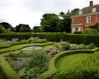 parterre garden planted with roses and bedding plants in a design by Richard Miers